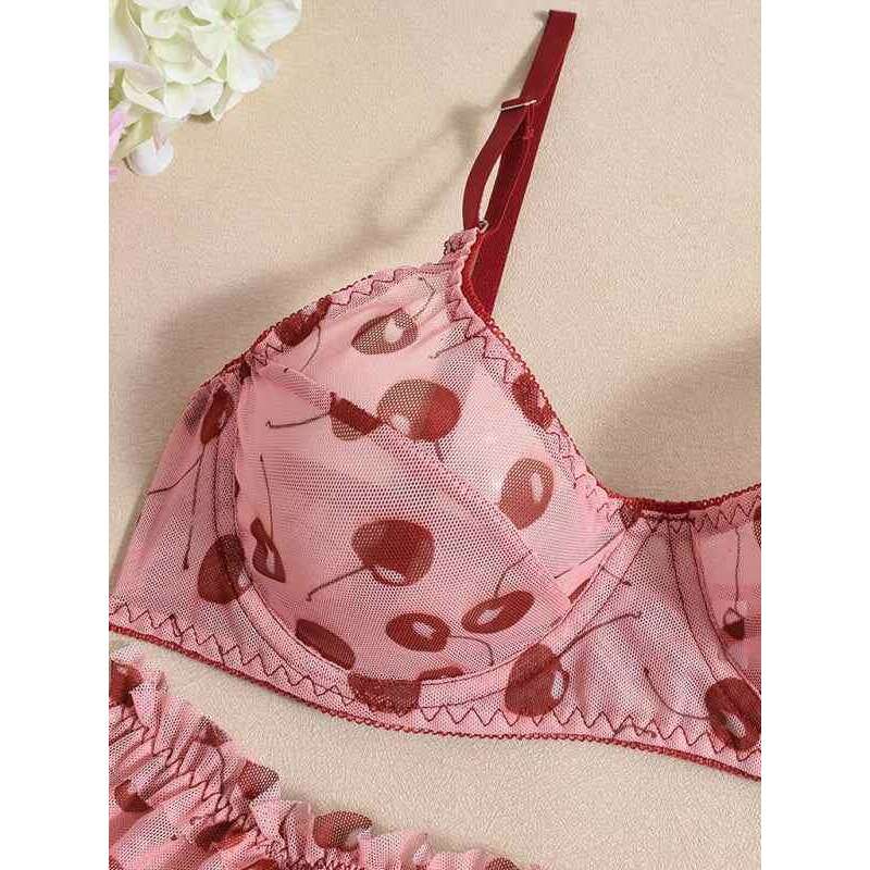 Red biodegradable yoga workout set featuring a sheer bra with a pattern and matching panties