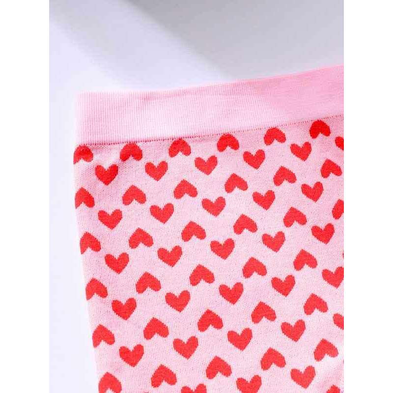 Smiling Maria Valentine's lingerie set for women featuring a playful pink design with red hearts